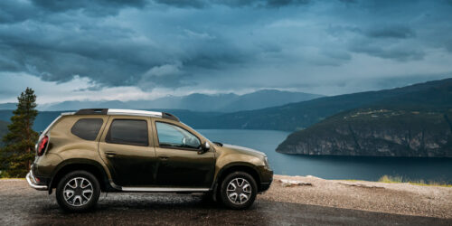 Utvik, Sogn Og Fjordane County, Norway. Car Suv Parked Near Scenic Route Road In Norwegian Mountain Lake Landscape. Innvikfjord Is A Sub-fjord Of Nordfjord.